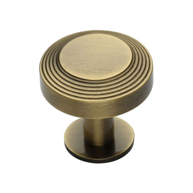 This is a image of a Heritage Brass - Cabinet Knob Ridge Design with Rose 32mm Ant. Brass Finish that is available to order from Trade Door Handles in Kendal