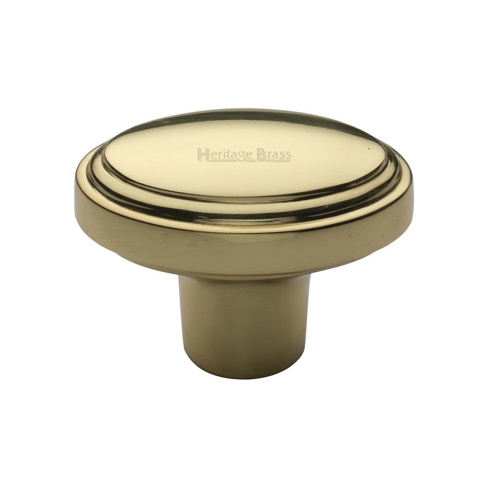 This is a image of a Heritage Brass - Cabinet Knob Stepped Oval Design 41mm Pol. Brass Finish that is available to order from Trade Door Handles in Kendal