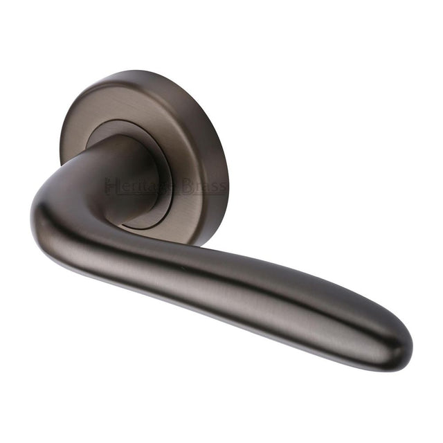 This is an image of a Heritage Brass - Door Handle Lever Latch on Round Rose Columbus Design Matt Bron, col1762-mb that is available to order from Trade Door Handles in Kendal.