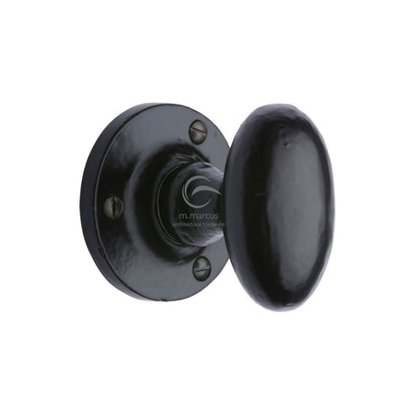 This is an image of a M.Marcus - Black Iron Rustic Mortice Knob on Rose Knowle Design, fb4555 that is available to order from Trade Door Handles in Kendal.