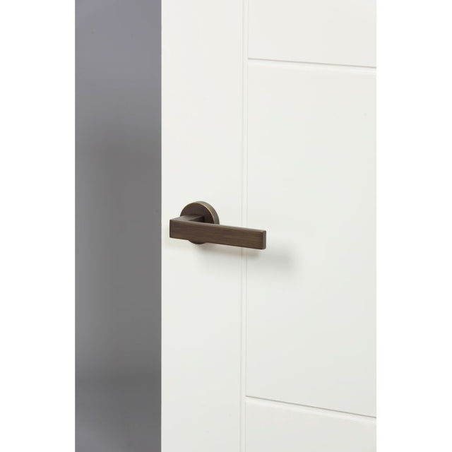 High quality image of Forme Asti Designer Lever on Minimal Round Rose - Urban Bronze | Sku. fmr254ub | available to order from Trade Door Handles in Kendal.