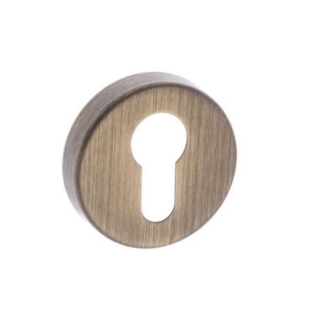 This is an image of Forme Euro Escutcheon on Minimal Round Rose - Yester Bronze available to order from Trade Door Handles.