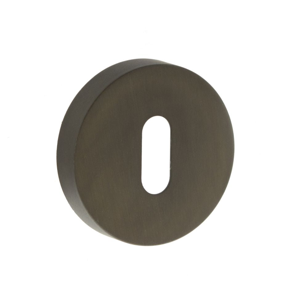 This is an image of Forme Key Escutcheon on Minimal Round Rose - Urban Dark Bronze available to order from Trade Door Handles.