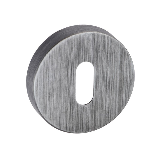 This is an image of Forme Key Escutcheon on Minimal Round Rose - Urban Graphite available to order from Trade Door Handles.