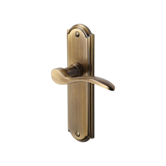 This is an image of a Heritage Brass - Door Handle Lever Latch Howard Design Antique Brass Finish, how1310-at that is available to order from Trade Door Handles in Kendal.