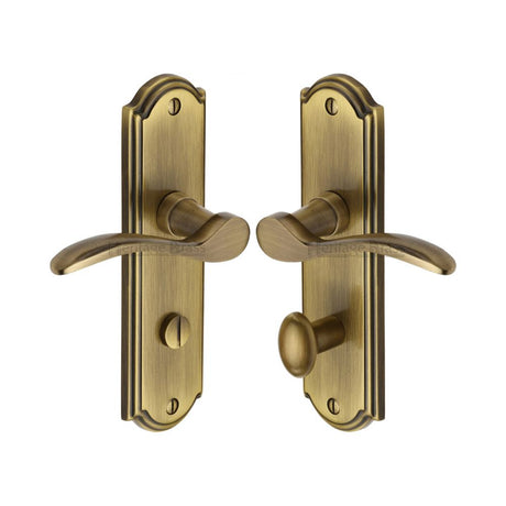 This is an image of a Heritage Brass - Door Handle for Bathroom Howard Design Antique Brass Finish, how1330-at that is available to order from Trade Door Handles in Kendal.