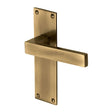 This is an image of a Heritage Brass - Door Handle Lever Latch Metro Design Antique Brass Finish, met4910-at that is available to order from Trade Door Handles in Kendal.