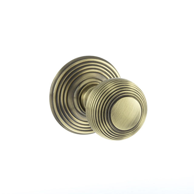 This is an image of Old English Ripon Solid Brass Reeded Mortice Knob on Concealed Fix Rose - Antiqu available to order from Trade Door Handles.