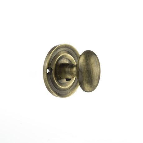 This is an image of Old English Solid Brass Oval WC Turn and Release - Antique Brass available to order from Trade Door Handles.