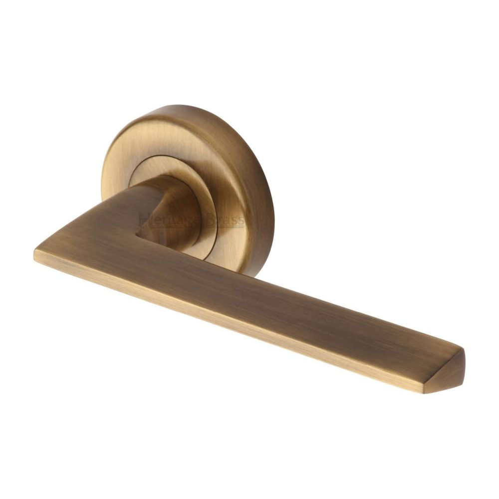 This is an image of a Heritage Brass - Door Handle Lever Latch on Round Rose Pyramid Design Antique Brass, pyd3535-at that is available to order from Trade Door Handles in Kendal.