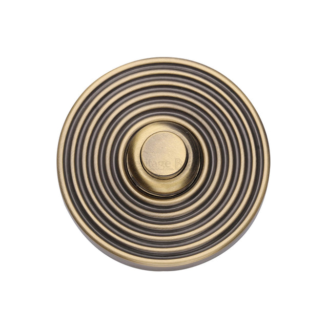 This is an image of a Heritage Brass - Reeded Bell Push Antique Brass finish, rr1186-at that is available to order from Trade Door Handles in Kendal.