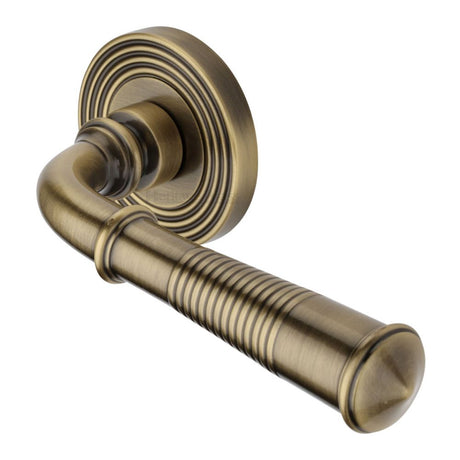 This is an image of a Heritage Brass - Door Handle Lever Latch on Round Rose Bridgetown Reeded Design, rr1935-at that is available to order from Trade Door Handles in Kendal.