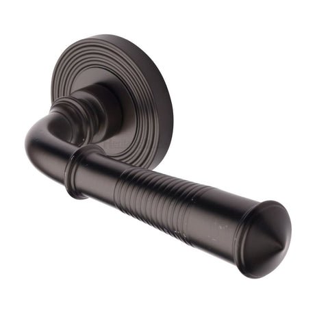 This is an image of a Heritage Brass - Door Handle Lever Latch on Round Rose Bridgetown Reeded Design, rr1935-mb that is available to order from Trade Door Handles in Kendal.