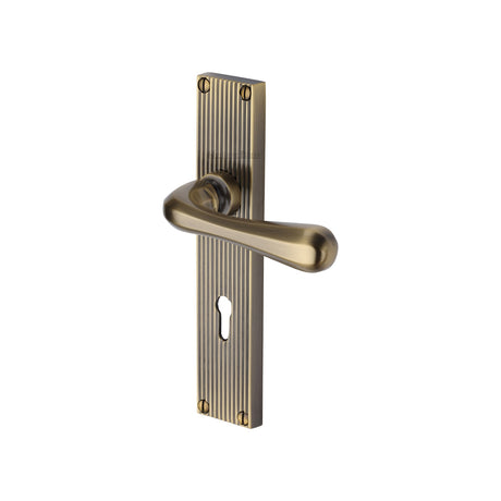 This is an image of a Heritage Brass - Charlbury Reeded Lever Lock Antique Brass finish, rr3000-at that is available to order from Trade Door Handles in Kendal.