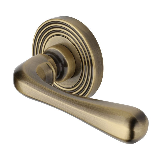 This is an image of a Heritage Brass - Door Handle Lever Latch on Round Rose Charlbury Reeded Design A, rr3022-at that is available to order from Trade Door Handles in Kendal.