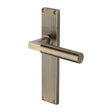 This is an image of a Heritage Brass - Bauhaus Reeded Lever Latch Antique Brass finish, rr7310-at that is available to order from Trade Door Handles in Kendal.