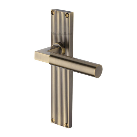 This is an image of a Heritage Brass - Bauhaus Reeded Lever Latch Antique Brass finish, rr7310-at that is available to order from Trade Door Handles in Kendal.