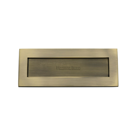 This is an image of a Heritage Brass - Reeded Letterplate 10" x 4" Antique Brass finish, rr852-254-101-at that is available to order from Trade Door Handles in Kendal.