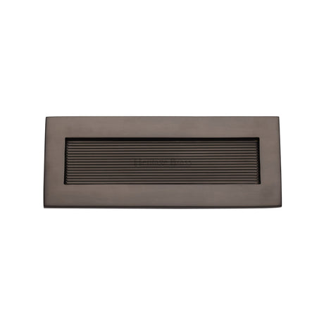 This is an image of a Heritage Brass - Reeded Letterplate 10" x 4" Matt Bronze finish, rr852-254-101-mb that is available to order from Trade Door Handles in Kendal.