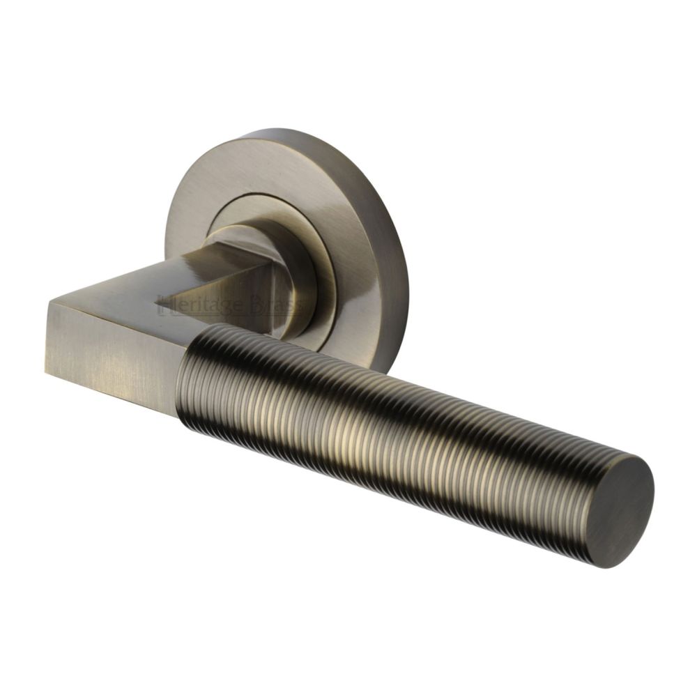 This is an image of a Heritage Brass - Door Handle Lever on Rose Spectral Design Antique Brass Finish, rs2261-at that is available to order from Trade Door Handles in Kendal.