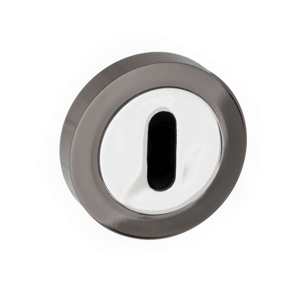 This is an image of STATUS Key Escutcheon on Round Rose - Black Nickel/Polished Chrome available to order from Trade Door Handles.