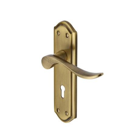 This is an image of a Heritage Brass - Door Handle Lever Lock Sandown Design Antique Brass Finish, san1400-at that is available to order from Trade Door Handles in Kendal.