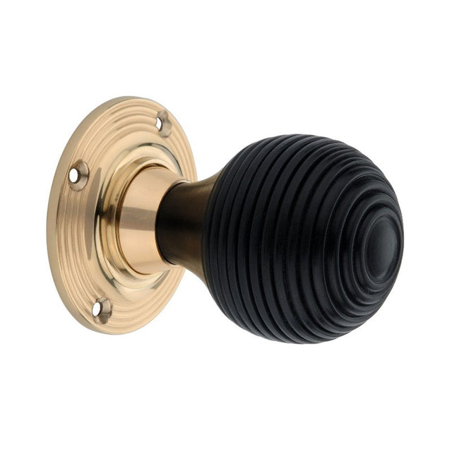 This is an image of Spira Brass - Ebony Beehive Rim/Mortice Door Knob Polished Brass   available to order from trade door handles, quick delivery and discounted prices.