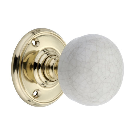 This is an image of Spira Brass - Crackled Porcelain Mortice Door Knob Polished Brass   available to order from trade door handles, quick delivery and discounted prices.