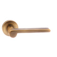 High quality image of Senza Pari Darrio Designer Lever on Round Rose - Weathered Antique Bronze | Sku. spm218wab | available to order from Trade Door Handles in Kendal.