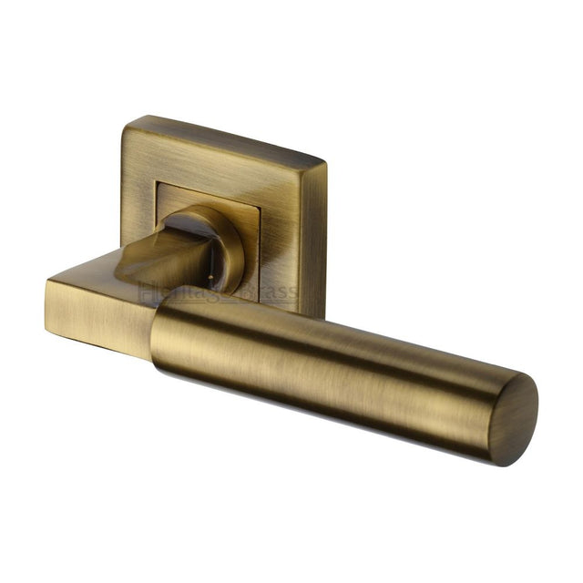 This is an image of a Heritage Brass - Door Handle Lever on Rose Bauhaus Sq Design Antique Brass Finish, sq1926-at that is available to order from Trade Door Handles in Kendal.