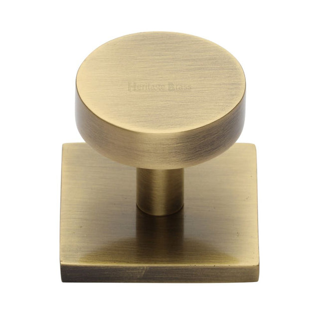 This is an image of a Heritage Brass - Cabinet Knob Disc Design with Square Backplate 32mm Antique Brass, sq3880-at that is available to order from Trade Door Handles in Kendal.