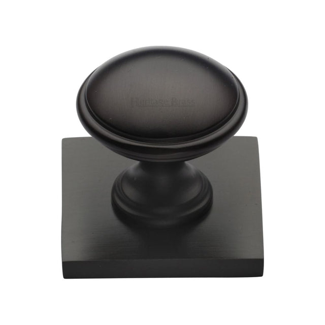 This is an image of a Heritage Brass - Cabinet Knob Domed Design with Square Backplate 32mm Matt Bronz, sq3950-mb that is available to order from Trade Door Handles in Kendal.