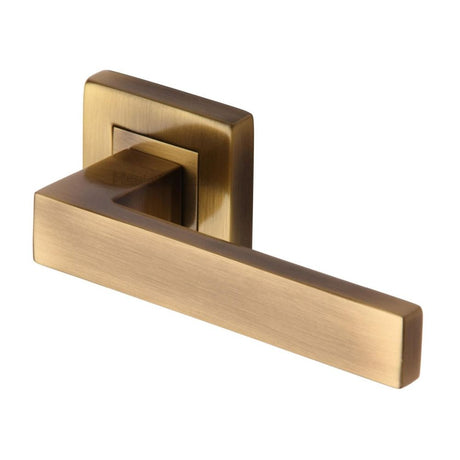 This is an image of a Heritage Brass - Door Handle Lever Latch on Square Rose Delta Sq Design Antique Bra, sq5420-at that is available to order from Trade Door Handles in Kendal.