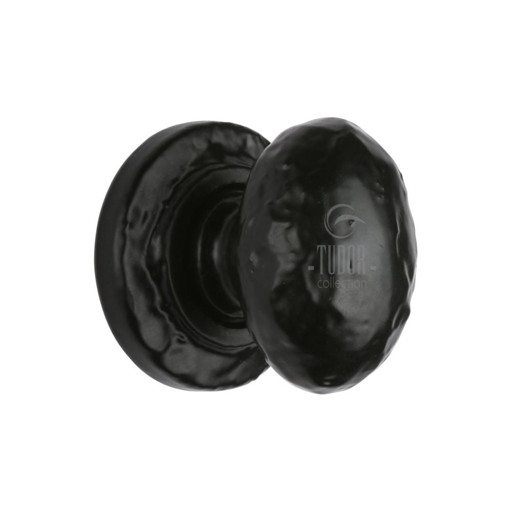 This is an image of a The Tudor Collection - Cabinet Knob Rustic Oval Design 32mm Black Iron, tc534-32 that is available to order from Trade Door Handles in Kendal.