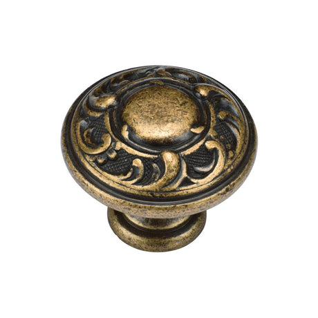 This is an image of a M.Marcus - Decorated Round Knob 035mm Distressed Brass Finish, tk4401-035-dbs that is available to order from Trade Door Handles in Kendal.