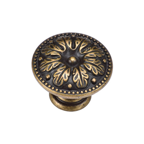 This is an image of a M.Marcus - Floral Round Knob 030mm Distressed Brass Finish, tk4479-030-dbs that is available to order from Trade Door Handles in Kendal.