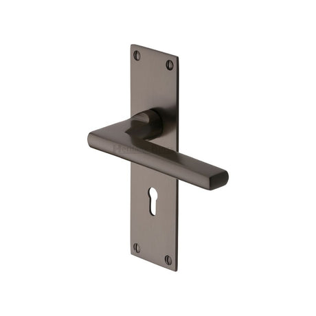 This is an image of a Heritage Brass - Door Handle Lever Lock Trident Design Matt Bronze Finish, tri1300-mb that is available to order from Trade Door Handles in Kendal.