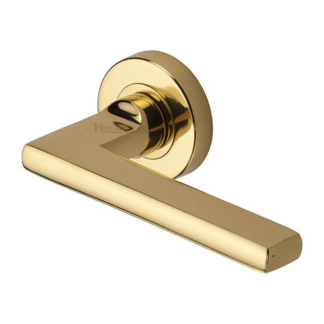 This is an image of a Heritage Brass - Door Handle Lever Latch on Round Rose Trident Design Polished Brass, tri1352-pb that is available to order from Trade Door Handles in Kendal.