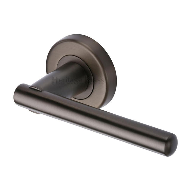 This is an image of a Heritage Brass - Door Handle Lever on Rose Challenger Design Matt Bronze Finish, v1001-mb that is available to order from Trade Door Handles in Kendal.