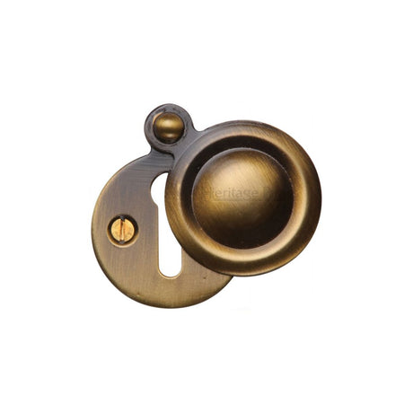 This is an image of a Heritage Brass - Covered Keyhole Round Antique Brass Finish, v1020-at that is available to order from Trade Door Handles in Kendal.