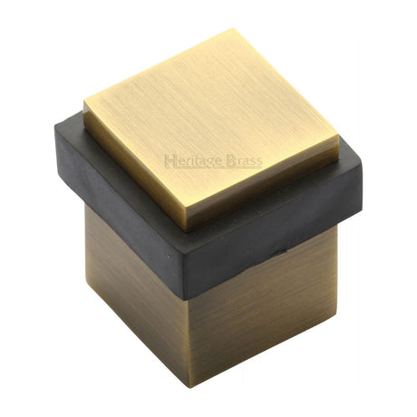 This is an image of a Heritage Brass - Door Stop Square Floor Mounted Design Antique Brass Finish, v1089-at that is available to order from Trade Door Handles in Kendal.