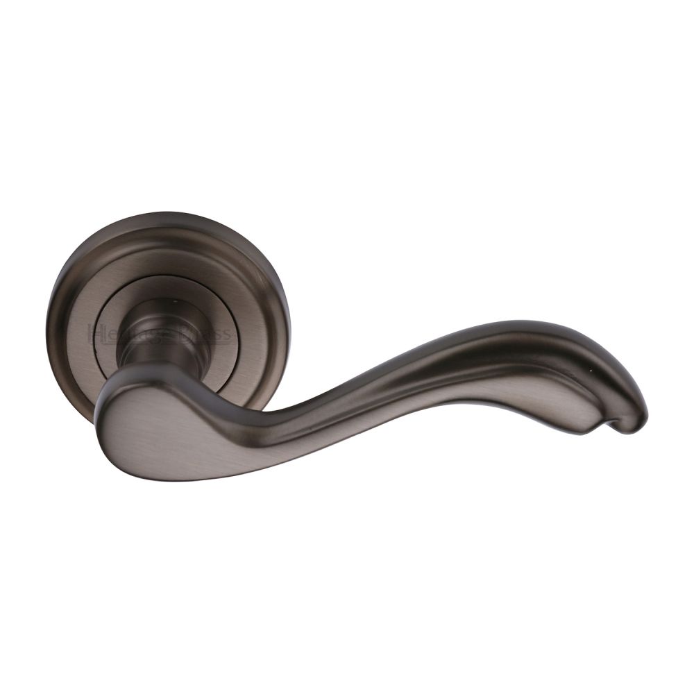 This is an image of a Heritage Brass - Door Handle Lever Latch on Round Rose Lisboa Design Matt Bronze, v1601-mb that is available to order from Trade Door Handles in Kendal.