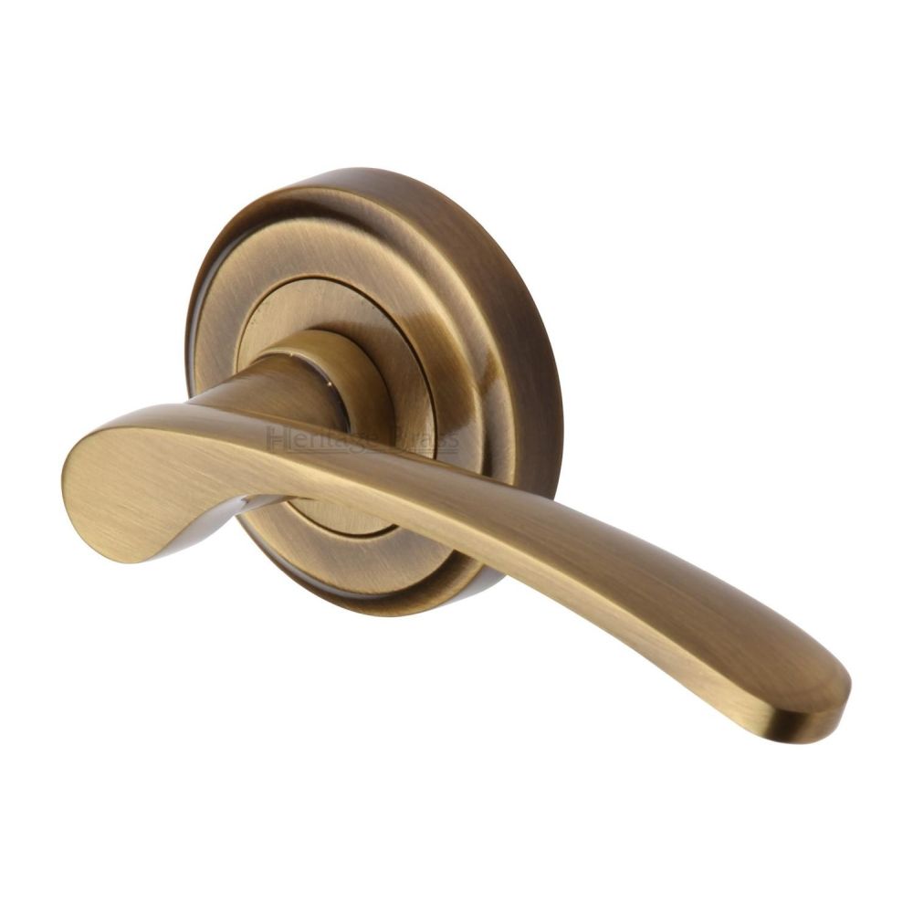 This is an image of a Heritage Brass - Door Handle Lever Latch on Round Rose Sophia Design Antique Brass, v1900-at that is available to order from Trade Door Handles in Kendal.