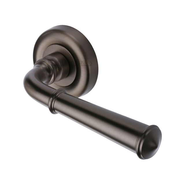 This is an image of a Heritage Brass - Door Handle Lever Latch on Round Rose Colonial Design Matt Bron, v1932-mb that is available to order from Trade Door Handles in Kendal.