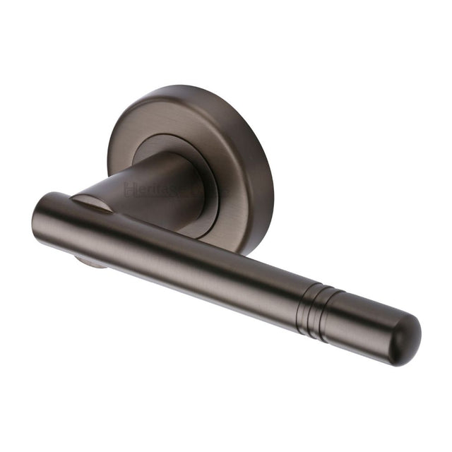 This is an image of a Heritage Brass - Door Handle Lever Latch on Round Rose Alicia Design Matt Bronze, v2100-mb that is available to order from Trade Door Handles in Kendal.