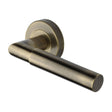 This is an image of a Heritage Brass - Door Handle Lever Latch on Round Rose Bauhaus Mitre Design Antique, v2270-at that is available to order from Trade Door Handles in Kendal.