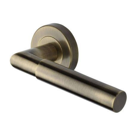 This is an image of a Heritage Brass - Door Handle Lever Latch on Round Rose Bauhaus Mitre Design Antique, v2270-at that is available to order from Trade Door Handles in Kendal.