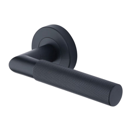 This is an image of a Heritage Brass - Door Handle Lever Latch on Round Rose Bauhaus Mitre Design Matt, v2272-bkmt that is available to order from Trade Door Handles in Kendal.