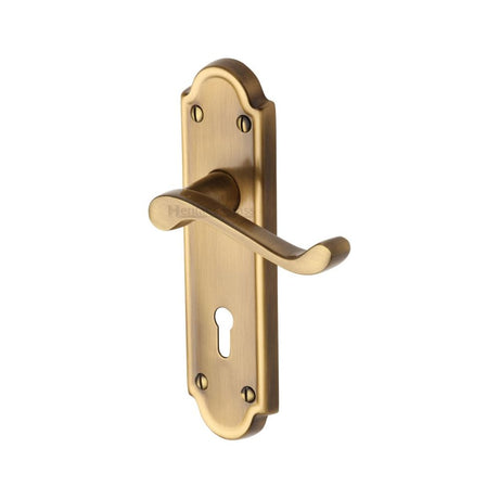 This is an image of a Heritage Brass - Door Handle Lever Lock Meridian Design Antique Brass Finish, v300-at that is available to order from Trade Door Handles in Kendal.