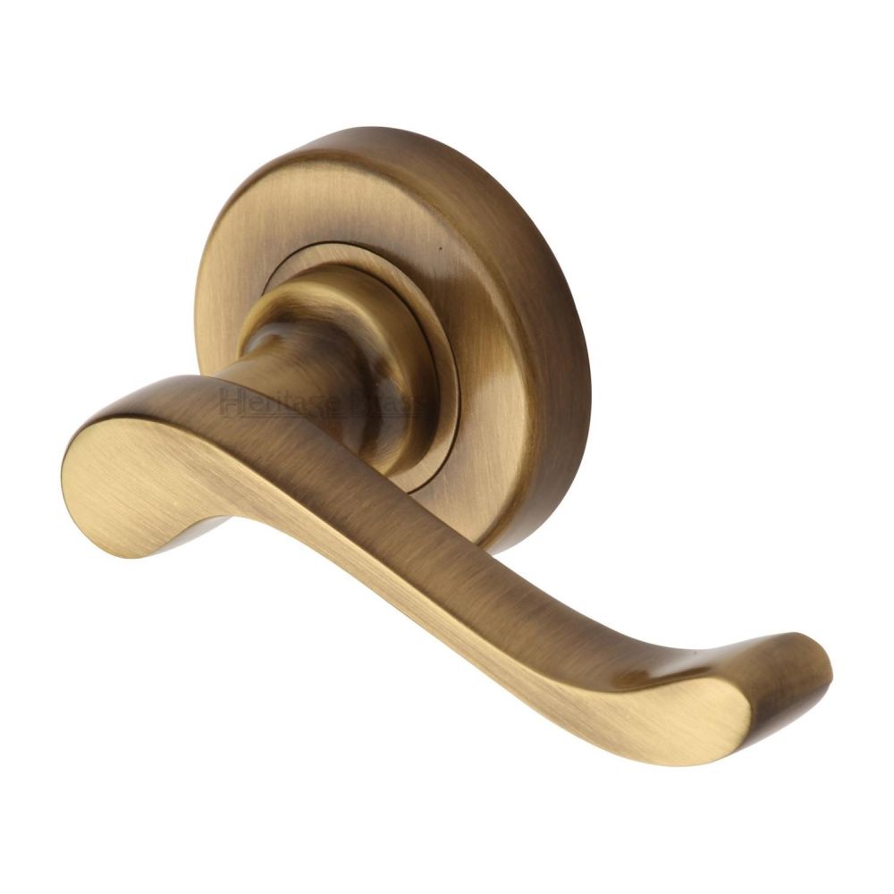 This is an image of a Heritage Brass - Door Handle Lever Latch on 53mm Round Rose Bedford Design Antique, v3010-at that is available to order from Trade Door Handles in Kendal.